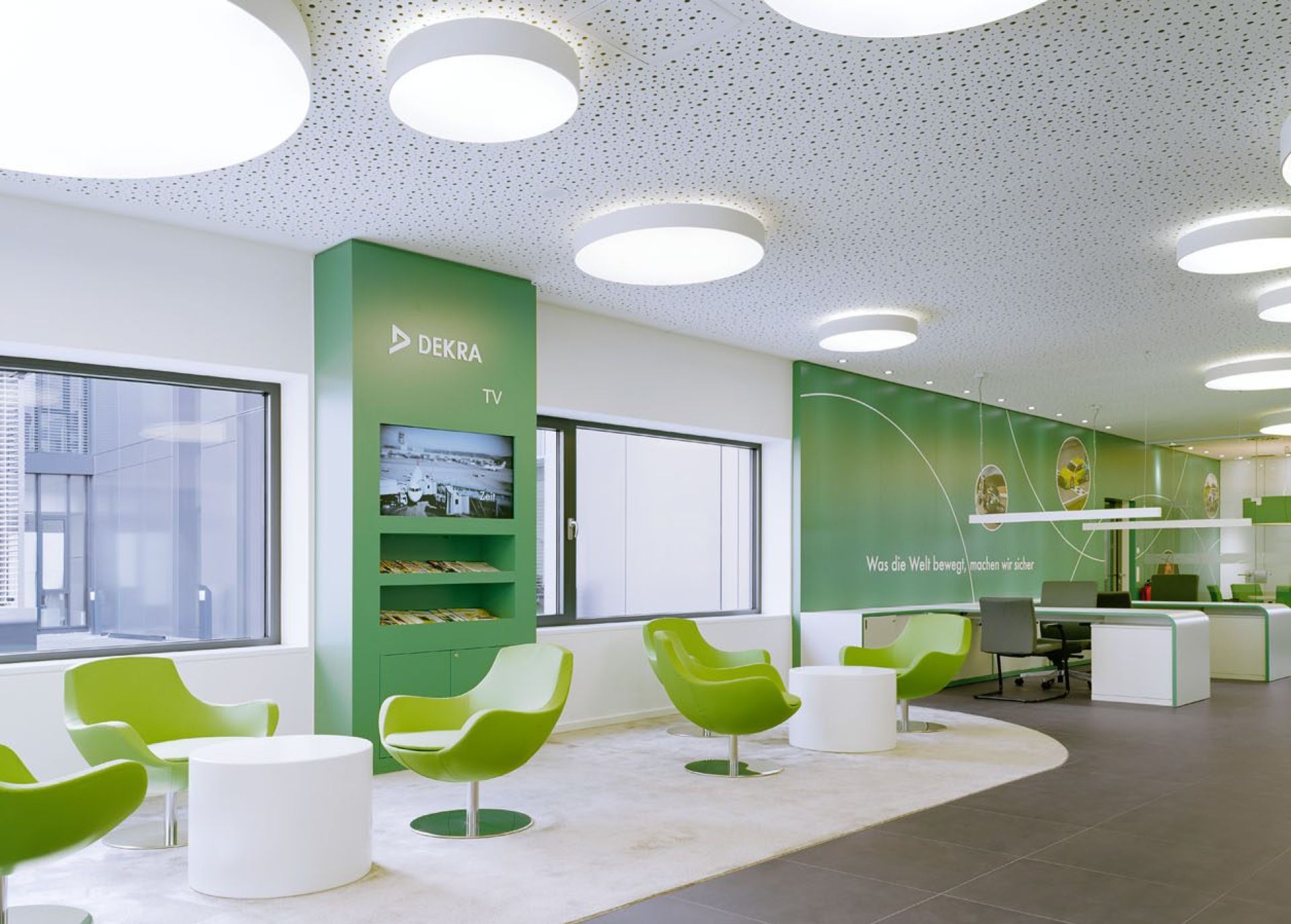 A white office with green chairs 