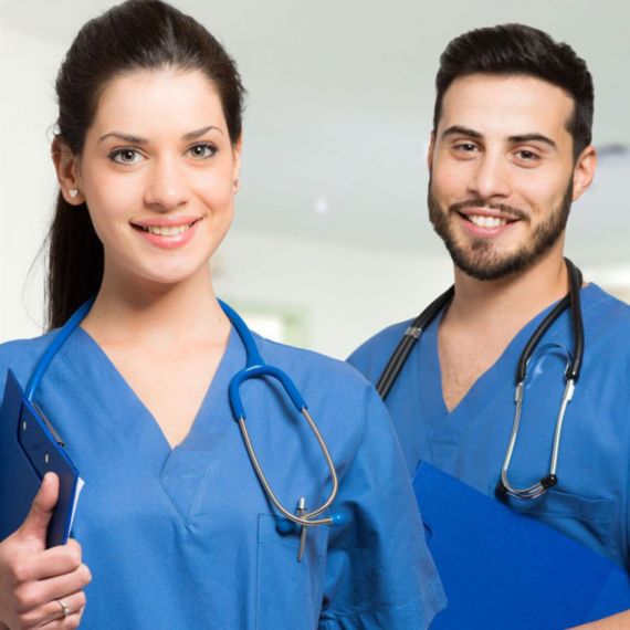 Two nursing students (one male and one female) with blue nursing uniforms